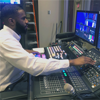 Anthony Nickens, Production Assistant, Medical News Network, working at the switcher in the master control.
