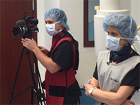Logan Blankenship, Videographer and Director of Morning Media Update, Medical News Network, videotaping a medical procedure.